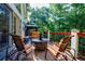 Outdoor patio with wood deck, comfy seating, and views of the serene, wooded backyard at 525 Avala Ct, Johns Creek, GA 30022