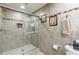 Bathroom with glass enclosed shower, decorative tile accent and neutral tile at 525 Avala Ct, Johns Creek, GA 30022