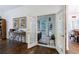 Bright sunroom entry boasts hardwood floors, glass French doors, and elegant decor elements at 525 Avala Ct, Johns Creek, GA 30022