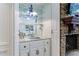 Close up of an elegant wet bar, featuring granite countertop and glass shelving at 525 Avala Ct, Johns Creek, GA 30022