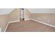 Finished attic space featuring slanted ceilings, modern flooring and neutral paint that creates a bright and inviting space at 5705 Cannonero Dr Dr, Alpharetta, GA 30005
