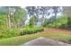 View of the backyard and neighboring houses with mature trees and natural landscaping at 5705 Cannonero Dr Dr, Alpharetta, GA 30005