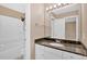 Bathroom featuring granite countertops, white cabinets, and a tub-shower combo at 5705 Cannonero Dr Dr, Alpharetta, GA 30005