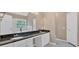 Double vanity bathroom with granite countertop, white cabinetry, and bathtub at 5705 Cannonero Dr Dr, Alpharetta, GA 30005