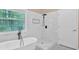 Elegant bathroom featuring a freestanding tub and walk-in shower with white tile at 5705 Cannonero Dr Dr, Alpharetta, GA 30005