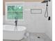 Modern bathroom with a freestanding tub and a large shower with a rain shower head at 5705 Cannonero Dr Dr, Alpharetta, GA 30005