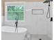 Modern bathroom features a sleek soaking tub and frameless glass shower at 5705 Cannonero Dr Dr, Alpharetta, GA 30005