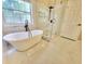 Modern bathroom features a sleek soaking tub and frameless glass shower at 5705 Cannonero Dr Dr, Alpharetta, GA 30005