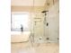 Elegant bathroom featuring a freestanding tub and a glass-enclosed shower with marble tiling and modern fixtures at 5705 Cannonero Dr Dr, Alpharetta, GA 30005