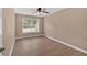 This bedroom features hardwood floors, a ceiling fan, and a window allowing for plenty of natural light at 5705 Cannonero Dr Dr, Alpharetta, GA 30005