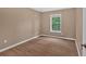 Cozy bedroom with wood floors, neutral walls, and a window that offers natural light at 5705 Cannonero Dr Dr, Alpharetta, GA 30005