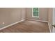 This bedroom features hardwood floors, a ceiling fan, and a window allowing for plenty of natural light at 5705 Cannonero Dr Dr, Alpharetta, GA 30005