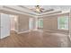 Spacious bedroom featuring a tray ceiling, ceiling fan, and large windows at 5705 Cannonero Dr Dr, Alpharetta, GA 30005