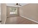 Cozy bedroom with a neutral color scheme, wood-look floors, and a large window at 5705 Cannonero Dr Dr, Alpharetta, GA 30005