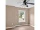 Empty bedroom featuring hardwood floors, a window, and neutral-colored walls at 5705 Cannonero Dr Dr, Alpharetta, GA 30005
