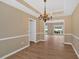 Dining room featuring a chandelier, wainscoting, and hardwood flooring at 5705 Cannonero Dr Dr, Alpharetta, GA 30005