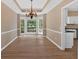 Dining area boasting a bay window, neutral walls with white trim, and an elegant chandelier at 5705 Cannonero Dr Dr, Alpharetta, GA 30005