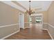 A stylish dining room is enhanced with a decorative chandelier, and views into the home's other living spaces at 5705 Cannonero Dr Dr, Alpharetta, GA 30005
