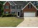 Traditional two-story home featuring brick and gray siding and an attached garage at 5705 Cannonero Dr Dr, Alpharetta, GA 30005