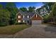 Charming two-story house with brick accents, a large garage, and a paved driveway at 5705 Cannonero Dr Dr, Alpharetta, GA 30005