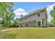 Back exterior view of two-story home with siding, large windows, and back yard at 5705 Cannonero Dr Dr, Alpharetta, GA 30005