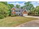 Charming two-story home with a brick and vinyl exterior, a well-manicured lawn, and an attached garage at 5705 Cannonero Dr Dr, Alpharetta, GA 30005