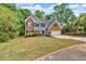 Charming two-story home with brick and siding exterior, landscaped yard, and a two-car garage at 5705 Cannonero Dr Dr, Alpharetta, GA 30005