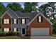 Two story home with brick and gray siding at 5705 Cannonero Dr Dr, Alpharetta, GA 30005