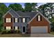 Charming two-story home featuring a combination of brick and siding exterior and a two-car garage at 5705 Cannonero Dr Dr, Alpharetta, GA 30005