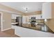 Modern kitchen with white cabinets, granite countertops, stainless steel appliances, and mosaic tile backsplash at 5705 Cannonero Dr Dr, Alpharetta, GA 30005