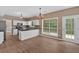 Eat-in kitchen boasts white cabinets, stainless appliances, granite counters and backyard views at 5705 Cannonero Dr Dr, Alpharetta, GA 30005