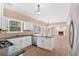 Bright, updated kitchen with granite countertops, and views of the living room at 5705 Cannonero Dr Dr, Alpharetta, GA 30005