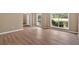 Bright living room featuring wood-look floors and large windows offering plenty of natural light at 5705 Cannonero Dr Dr, Alpharetta, GA 30005