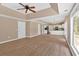 Open-concept living room with tray ceilings, hardwood floors, and kitchen views at 5705 Cannonero Dr Dr, Alpharetta, GA 30005