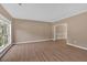 A bright living room with laminate wood floors and large windows, showing an open and airy space at 5705 Cannonero Dr Dr, Alpharetta, GA 30005