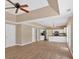 Open-concept living room featuring hardwood floors, tray ceilings and a modern kitchen with stainless steel appliances at 5705 Cannonero Dr Dr, Alpharetta, GA 30005