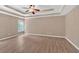 Spacious main bedroom features a tray ceiling, neutral walls, recessed lights, and hardwood floors at 5705 Cannonero Dr Dr, Alpharetta, GA 30005