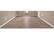A spacious, bright room with hardwood floors and neutral wall colors at 5705 Cannonero Dr Dr, Alpharetta, GA 30005