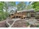 Lush backyard with a multi-level wooden deck, stone pathways, and mature landscaping at 2689 Cosmos Ne Dr, Atlanta, GA 30345