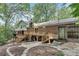 Expansive backyard featuring a wooden deck, stepped stone features, and mature trees at 2689 Cosmos Ne Dr, Atlanta, GA 30345