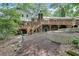 Spacious backyard with a wooden deck, stone retaining wall, and mature trees at 2689 Cosmos Ne Dr, Atlanta, GA 30345