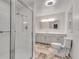 Bright bathroom featuring a glass-enclosed shower and a neutral-toned vanity with a large framed mirror at 2689 Cosmos Ne Dr, Atlanta, GA 30345
