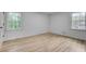 Bright bedroom with hardwood floors and natural light from two windows at 2689 Cosmos Ne Dr, Atlanta, GA 30345