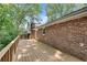 Spacious wooden deck, perfect for outdoor entertaining, with brick siding and mature trees at 2689 Cosmos Ne Dr, Atlanta, GA 30345