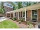 Charming front entrance featuring a brick facade, white columns, and a welcoming black door at 2689 Cosmos Ne Dr, Atlanta, GA 30345