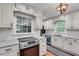Bright kitchen with granite counters, stainless steel appliances, white cabinets, and a modern light fixture at 2689 Cosmos Ne Dr, Atlanta, GA 30345