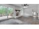 Cozy living room with a white-painted brick fireplace, wood mantel, ceiling fan and access to a rear deck at 2689 Cosmos Ne Dr, Atlanta, GA 30345