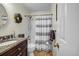 Well-lit bathroom with a shower-tub combo, tile flooring, and granite countertop vanity at 441 Belgrave Ln, Tucker, GA 30084