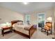 Comfortable bedroom showcasing a wooden bed frame, windows, and neutral décor at 441 Belgrave Ln, Tucker, GA 30084