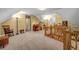 Bright bonus room featuring neutral walls and carpet, a window, and a wood railing overlooking the floor below at 441 Belgrave Ln, Tucker, GA 30084
